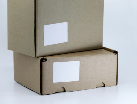 Single brown cardboard box sitting on a white table, ready for packing