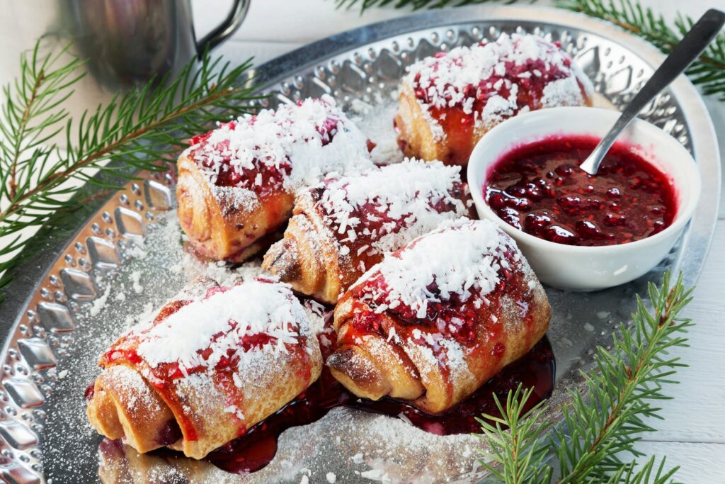Plate of Christmas rolled cookies with jam, a festive treat to share with coworkers