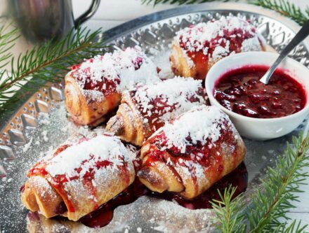 Plate of Christmas rolled cookies with jam, a festive treat to share with coworkers