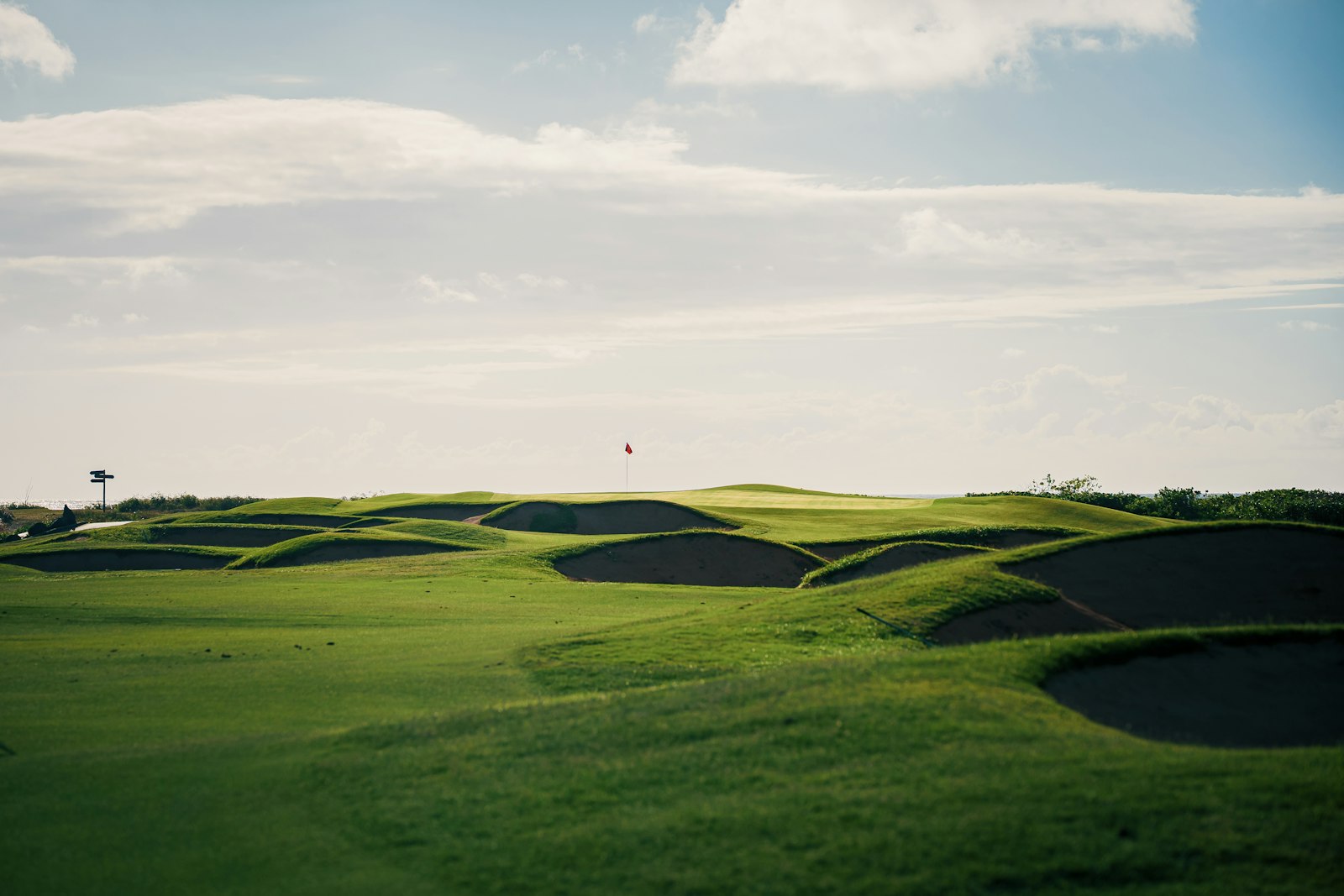 Undulating green golf course with several sand bunkers, a setting for a corporate retreat