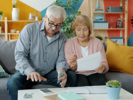 Elderly couple reviewing documents together at home, a reminder to get legal paperwork in place