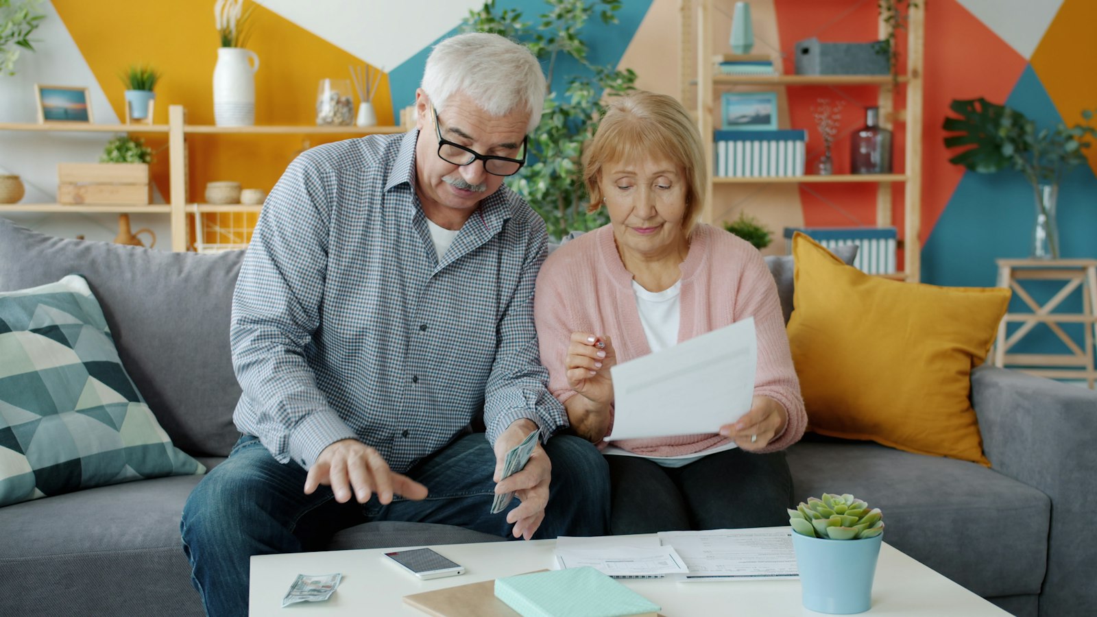 Elderly couple reviewing documents together at home, a reminder to get legal paperwork in place