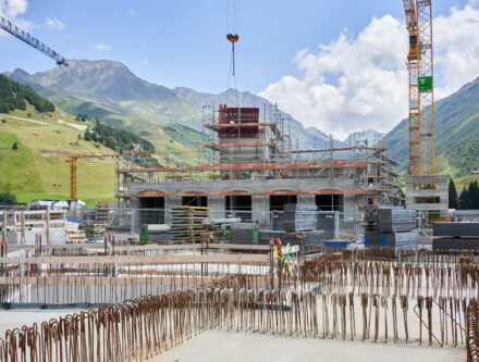 Construction site with cranes and a building under construction, showing modern building work