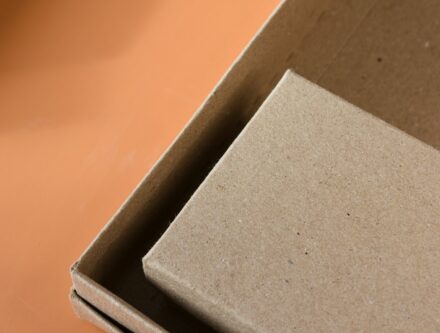 Open cardboard box on a table, representing sustainable packaging for businesses
