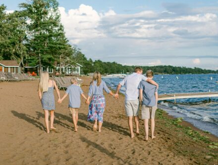 Family walking along the beach holding hands, evoking a holiday together
