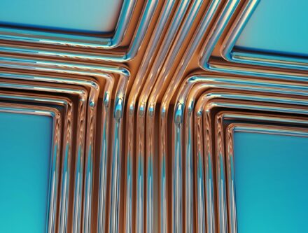 Copper pipes arranged in a cross shape against a blue background