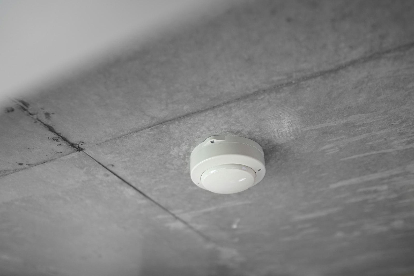 Fire alarm mounted on a ceiling, the kind of device that may need upgrading