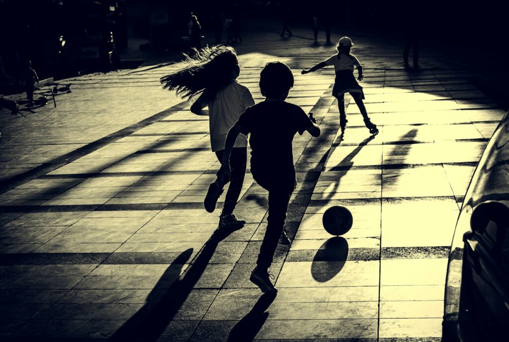 Group of young children playing a game of football, a lively idea for an active party