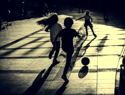 Group of young children playing a game of football, a lively idea for an active party