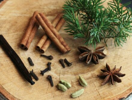 Assortment of spices on a wooden cutting board, ready for festive Christmas baking