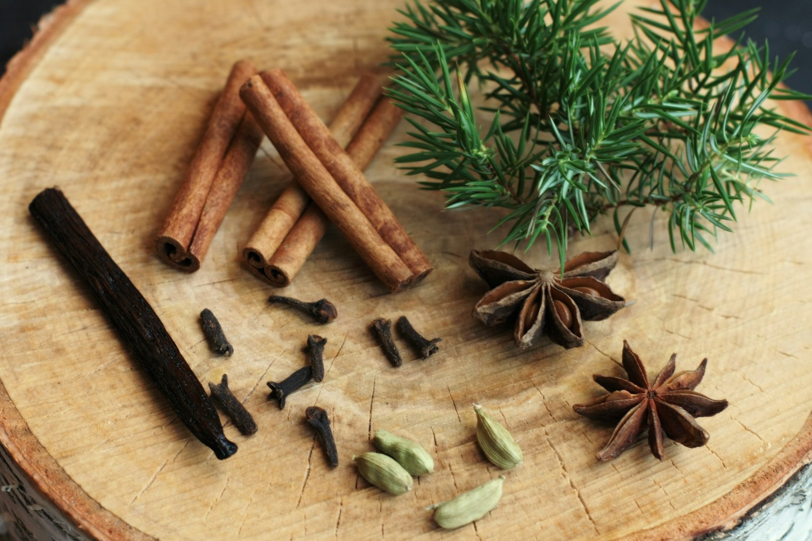 Assortment of spices on a wooden cutting board, ready for festive Christmas baking