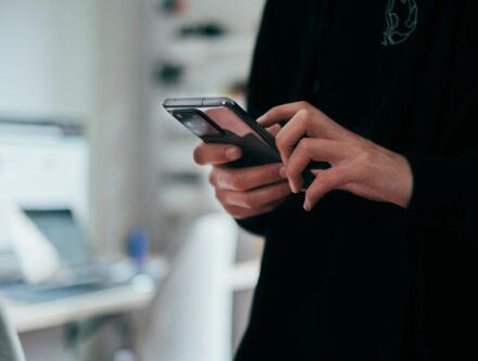 Person holding a black Android smartphone, the small screen most visitors use to browse websites