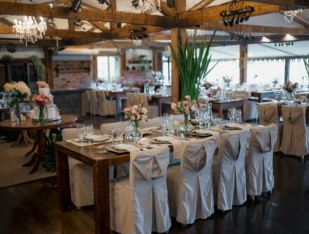Wedding reception hall with decorated tables and chandeliers, as a hotel venue might look
