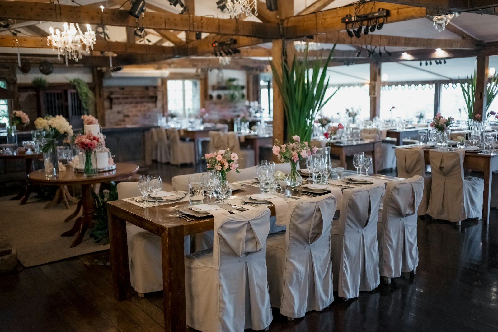 Wedding reception hall with decorated tables and chandeliers, as a hotel venue might look