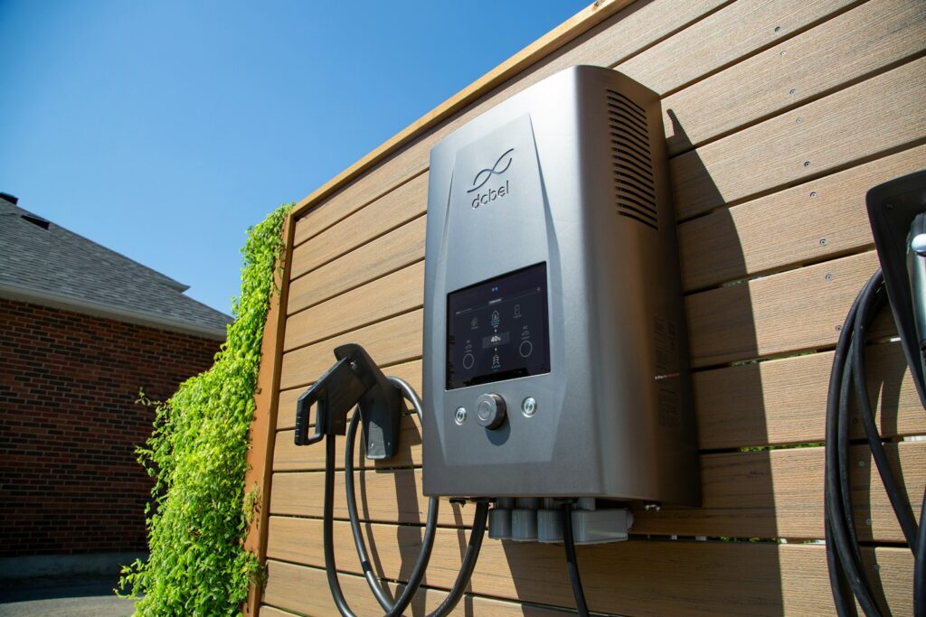 Electric car charger mounted on a wooden wall at a home